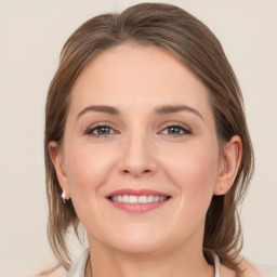 Joyful white young-adult female with medium  brown hair and grey eyes