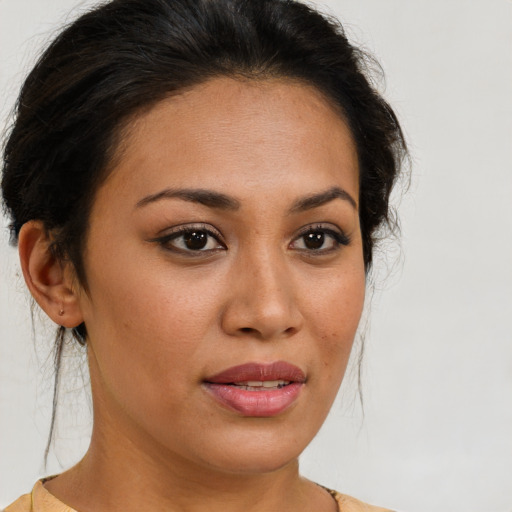 Joyful latino young-adult female with medium  brown hair and brown eyes