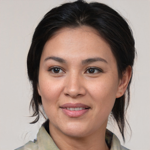 Joyful white adult female with medium  brown hair and brown eyes