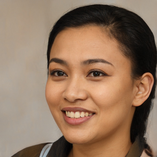 Joyful latino young-adult female with medium  brown hair and brown eyes