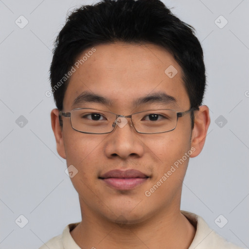 Joyful asian young-adult male with short  black hair and brown eyes