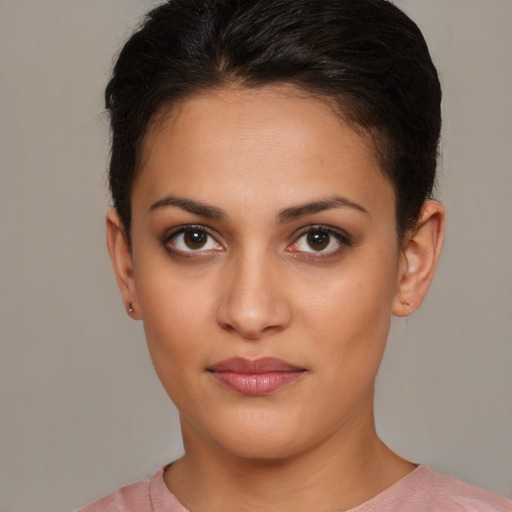 Joyful latino young-adult female with short  brown hair and brown eyes