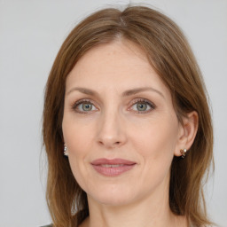 Joyful white adult female with medium  brown hair and green eyes