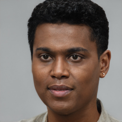 Joyful black young-adult male with short  black hair and brown eyes