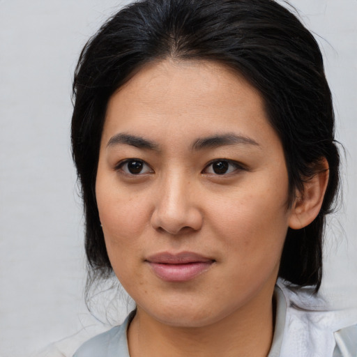 Joyful asian young-adult female with medium  brown hair and brown eyes