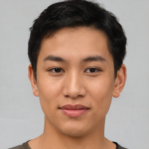 Joyful asian young-adult male with short  black hair and brown eyes