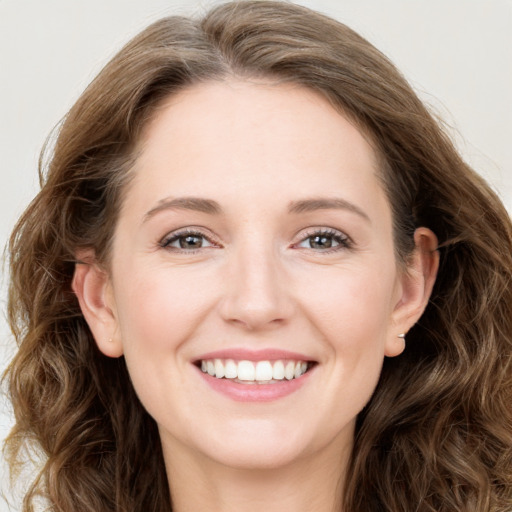 Joyful white young-adult female with long  brown hair and green eyes