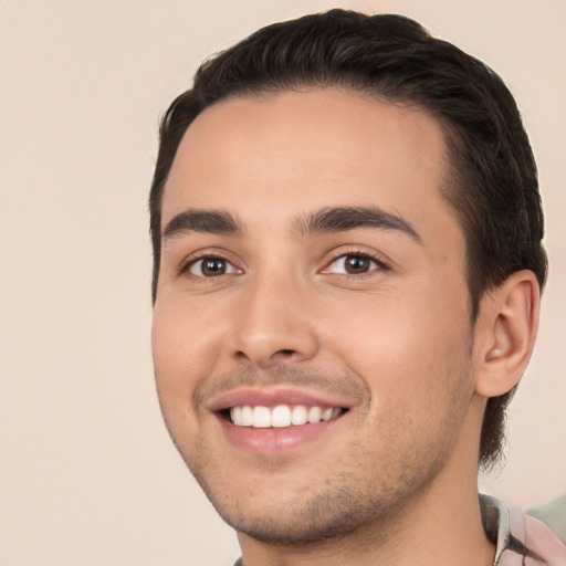 Joyful white young-adult male with short  brown hair and brown eyes