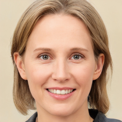 Joyful white young-adult female with medium  brown hair and blue eyes