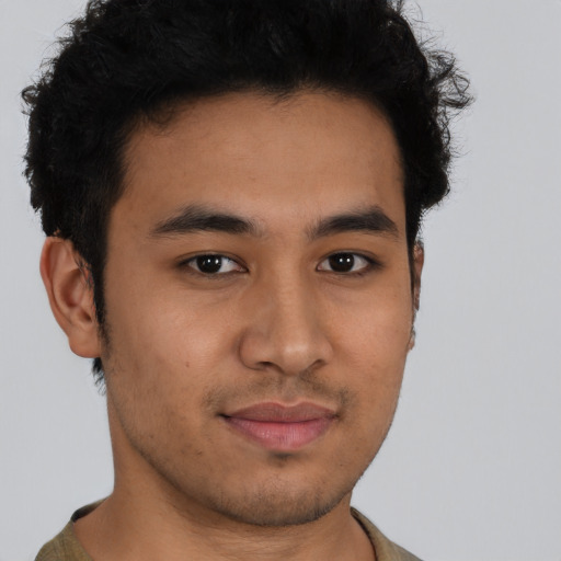 Joyful latino young-adult male with short  brown hair and brown eyes