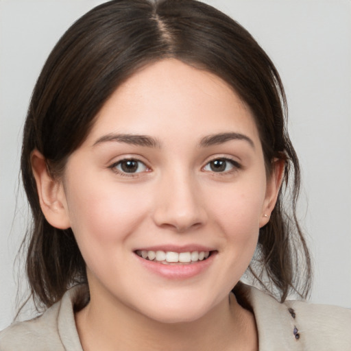 Joyful white young-adult female with medium  brown hair and brown eyes