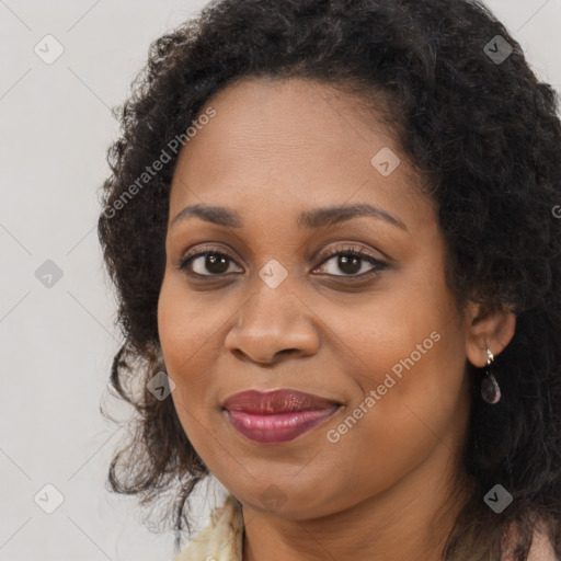 Joyful black adult female with long  brown hair and brown eyes