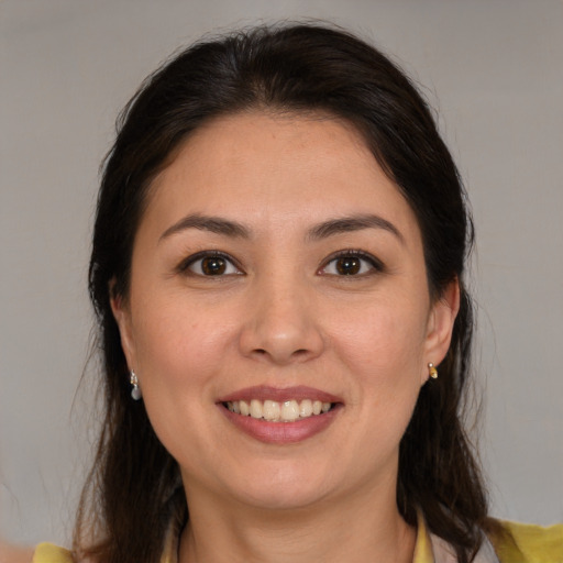 Joyful white young-adult female with medium  brown hair and brown eyes