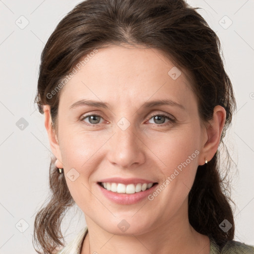 Joyful white young-adult female with medium  brown hair and grey eyes