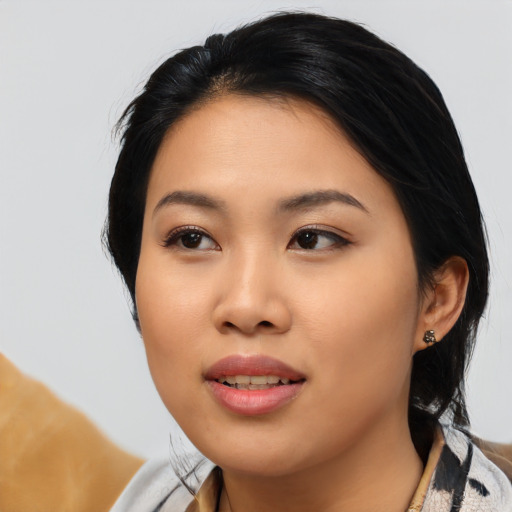 Joyful asian young-adult female with medium  black hair and brown eyes