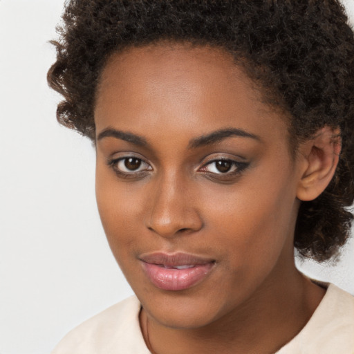 Neutral black young-adult female with medium  brown hair and brown eyes