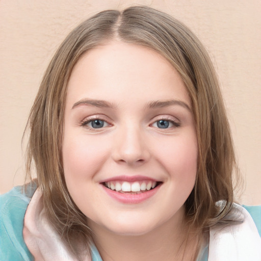 Joyful white child female with medium  brown hair and green eyes