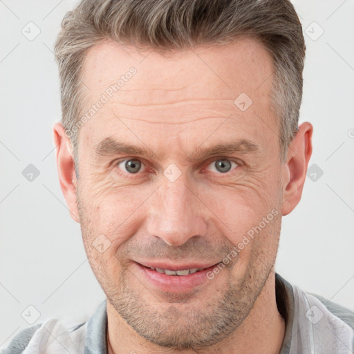 Joyful white adult male with short  brown hair and grey eyes