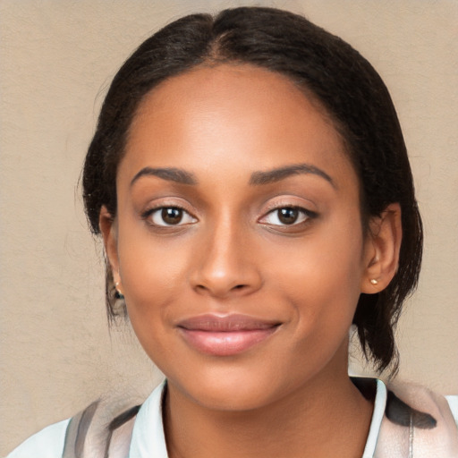 Joyful black young-adult female with medium  brown hair and brown eyes