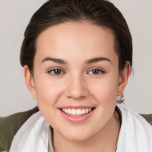 Joyful white young-adult female with medium  brown hair and brown eyes