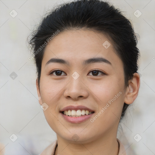 Joyful asian young-adult female with short  brown hair and brown eyes