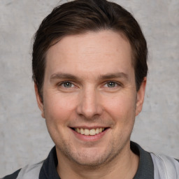 Joyful white adult male with short  brown hair and grey eyes