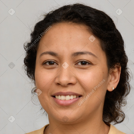 Joyful latino young-adult female with medium  brown hair and brown eyes