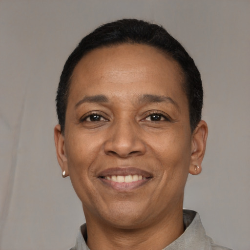 Joyful latino adult female with short  black hair and brown eyes