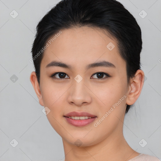 Joyful asian young-adult female with short  black hair and brown eyes