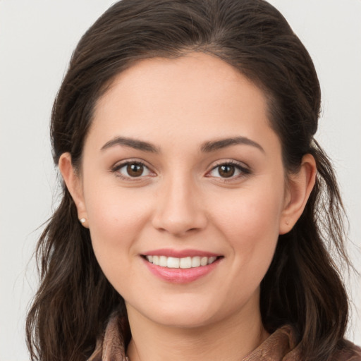 Joyful white young-adult female with long  brown hair and brown eyes