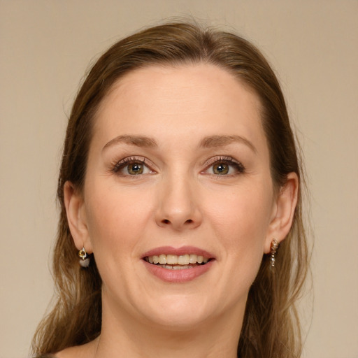 Joyful white young-adult female with long  brown hair and green eyes