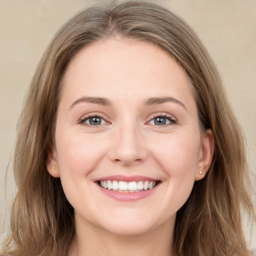 Joyful white young-adult female with long  brown hair and grey eyes