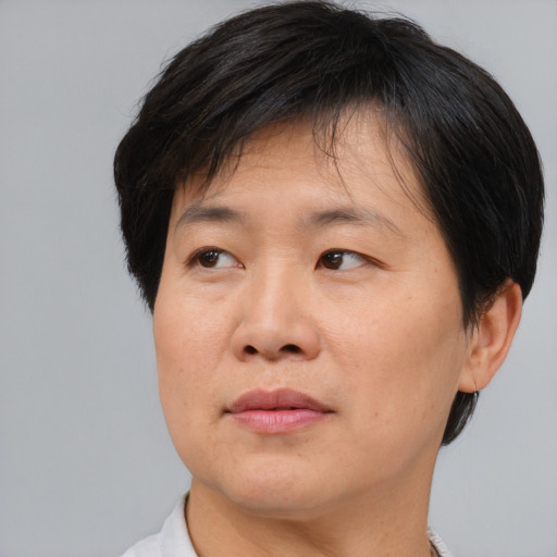 Joyful asian adult male with medium  brown hair and brown eyes