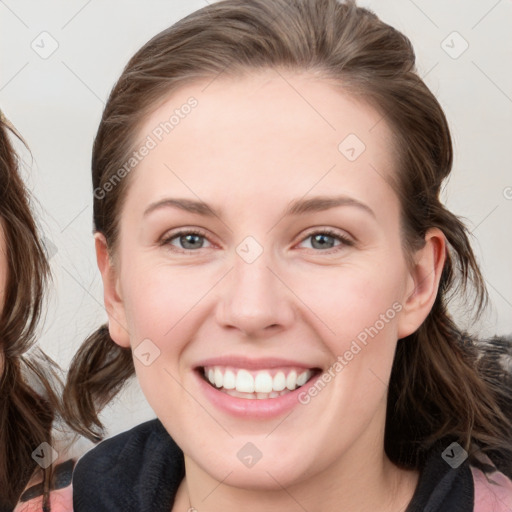 Joyful white young-adult female with medium  brown hair and blue eyes