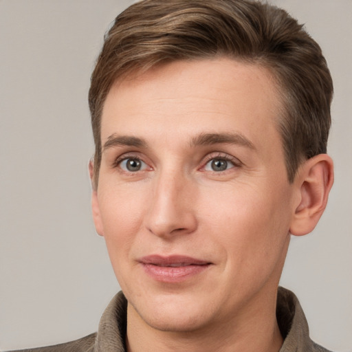 Joyful white adult male with short  brown hair and grey eyes