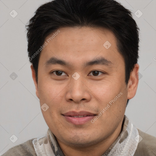 Joyful asian young-adult male with short  brown hair and brown eyes