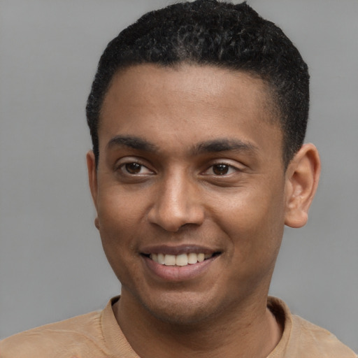 Joyful latino young-adult male with short  brown hair and brown eyes