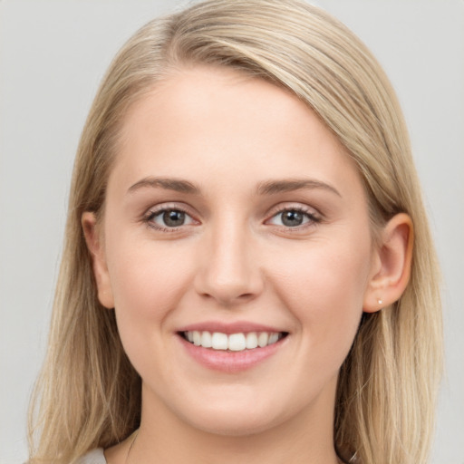 Joyful white young-adult female with long  brown hair and blue eyes