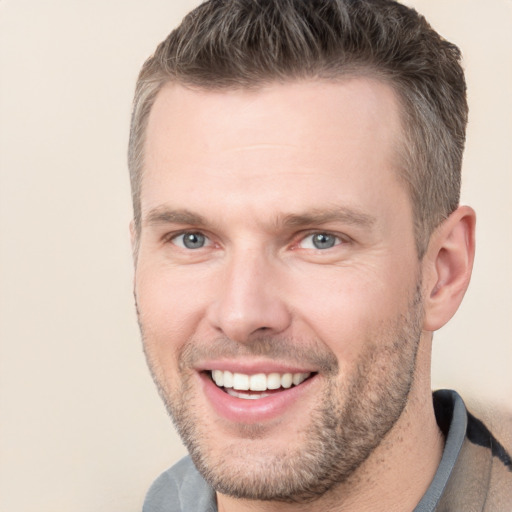 Joyful white adult male with short  brown hair and brown eyes