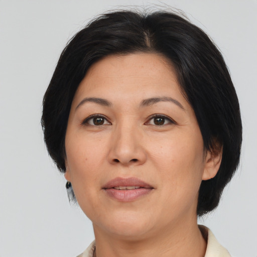Joyful asian adult female with medium  brown hair and brown eyes