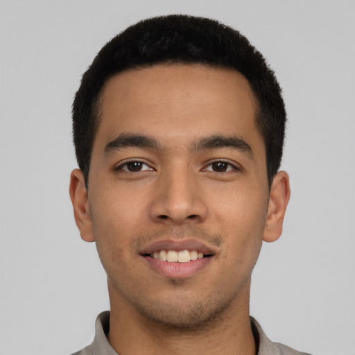 Joyful latino young-adult male with short  black hair and brown eyes