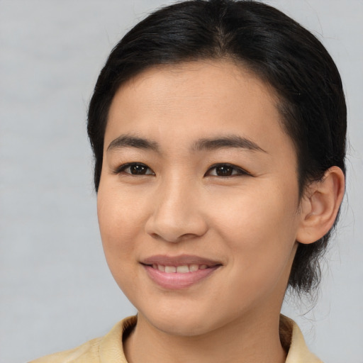 Joyful asian young-adult female with medium  brown hair and brown eyes