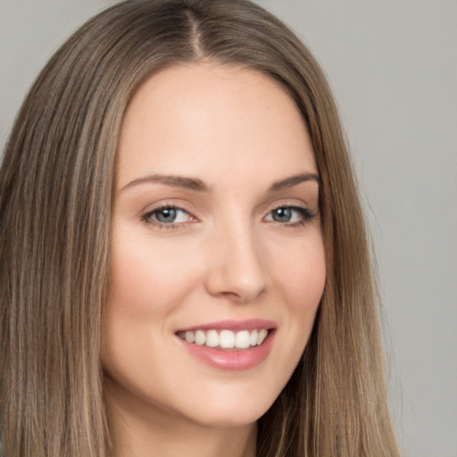 Joyful white young-adult female with long  brown hair and brown eyes