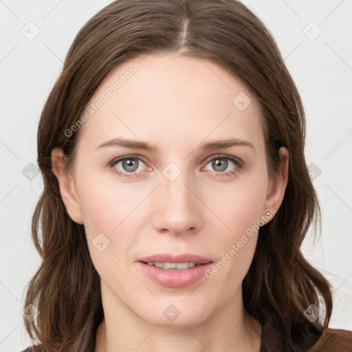 Joyful white young-adult female with long  brown hair and grey eyes