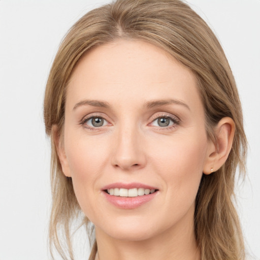 Joyful white young-adult female with medium  brown hair and blue eyes