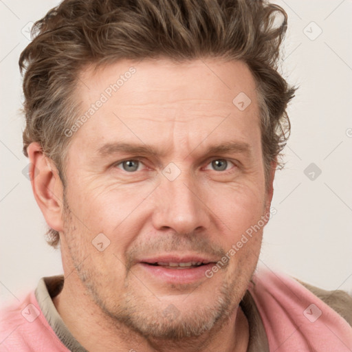 Joyful white adult male with short  brown hair and grey eyes