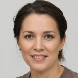 Joyful white adult female with medium  brown hair and brown eyes