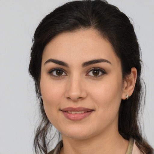 Joyful latino young-adult female with medium  brown hair and brown eyes