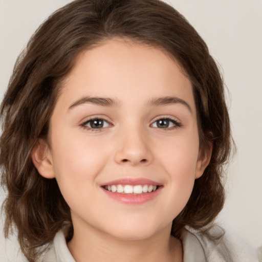 Joyful white child female with medium  brown hair and brown eyes