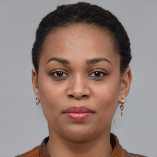 Joyful black young-adult female with short  brown hair and brown eyes